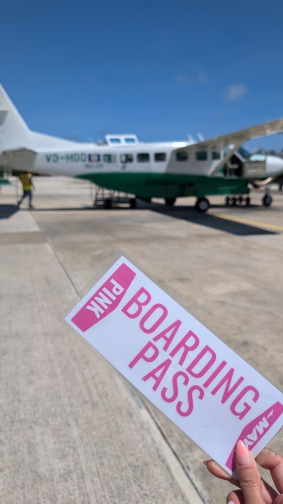 Boarding pass and small plane in background