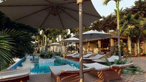 Centrally located pool amidst palm tree and sandy beach